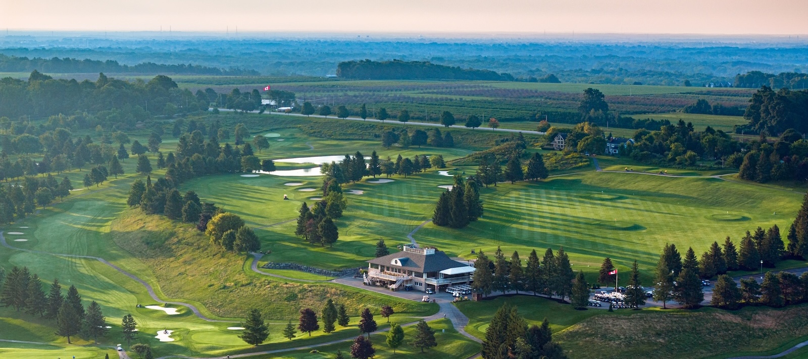 Aerial view of The Hawk golf course's clubhouse, fairways and greens.